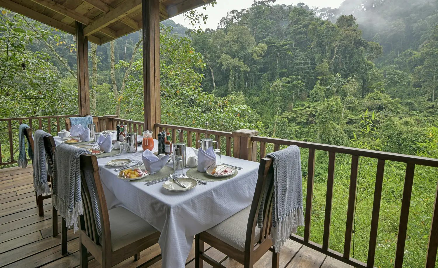 Breakfast table on the deck facing Bwindi forest at Four Gorillas Lodge
