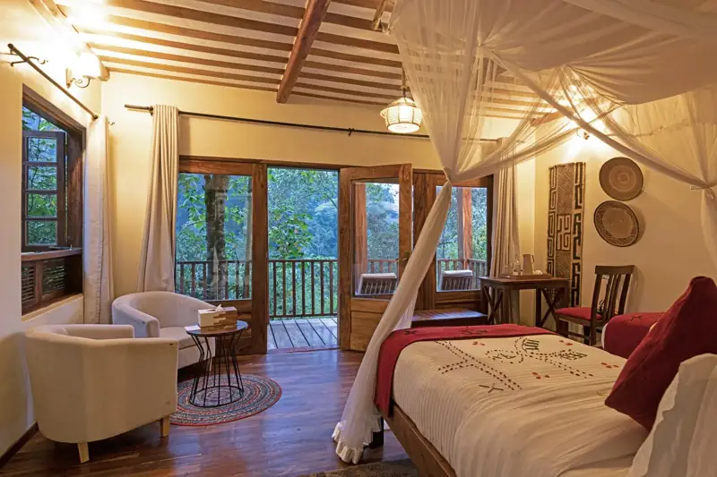 Twin cottage room with seating area at Four Gorillas Lodge, Rushaga