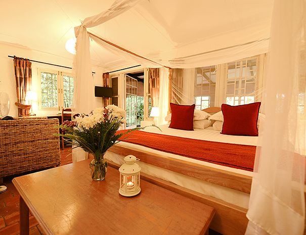 Garden room with four-poster bed at The Boma, Entebbe